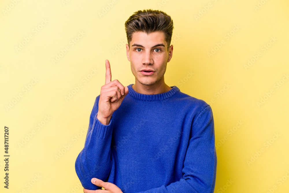 Young caucasian man isolated on yellow background having some great idea, concept of creativity. Young caucasian man isolated on yellow background having some great idea, concept of creativity.