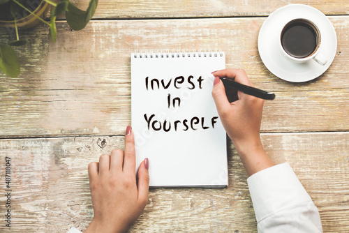 hand with invest in yourself text