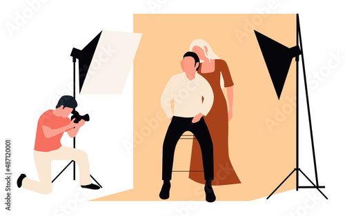Professional photographers taking pictures. Men and woman models posing in professional photography studio with cameras and light tripods.