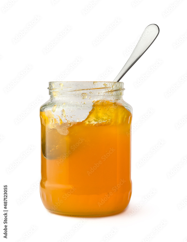 fruit jam bottle with a spoon, isolated on white background, closeup fruit jam bottle with a spoon, isolated on white background, closeup