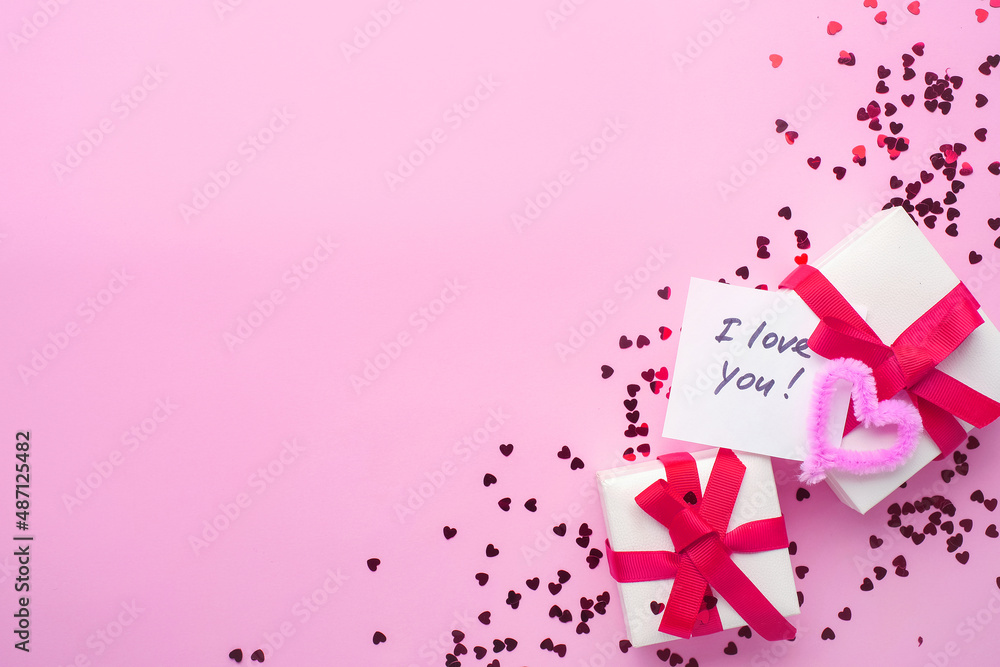 White boxes with gifts on a pink background. St. Valentine's Day. Fluffy hearts. Concept of love and spring. Top view, background, copy space. Lettering: I love you