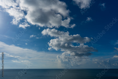 Natural daylight and white clouds floating on blue sky at sunny day over the sea