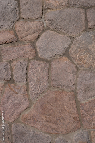 Pattern of ancient bricks and stones at old middle age wall  as a background  closeup  details.