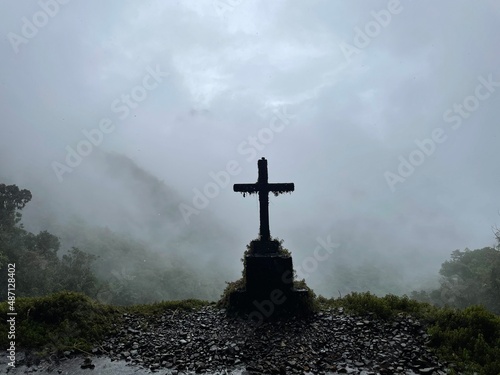 View of grave on edge of foggy Death Road, Bolivia