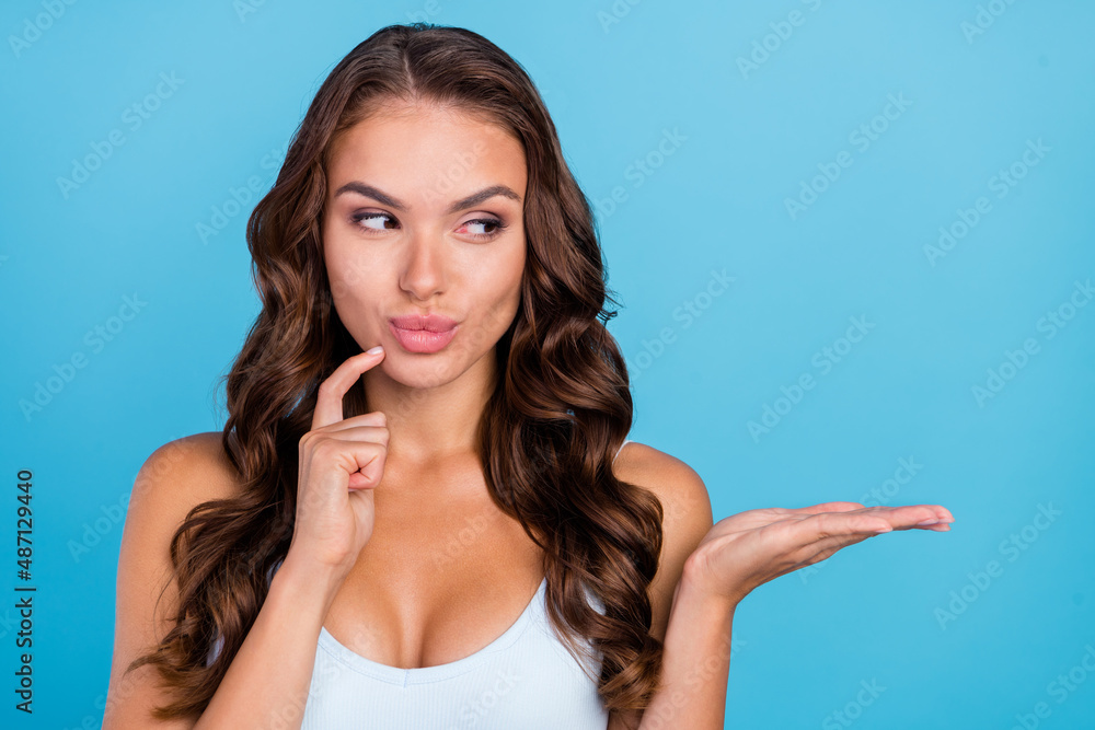 Photo of curious brunette curly hairstyle lady look advise wear teal singlet isolated on blue color background