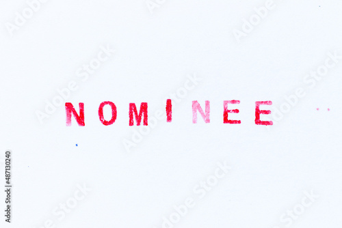 Red color ink rubber stamp in word nominee on white paper background