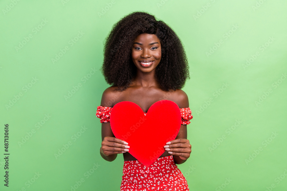 Photo of sweet millennial curly hairdo brunette lady hold postcard wear red top isolated on green color background Photo of sweet millennial curly hairdo brunette lady hold postcard wear red top isolated on green color background