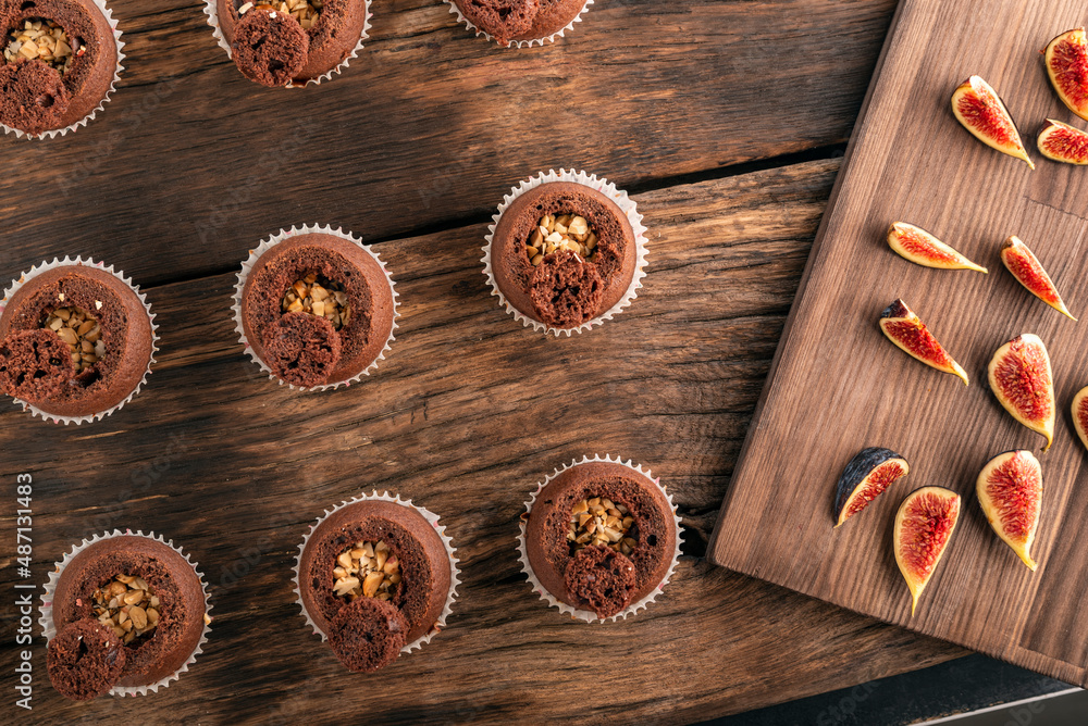 Top view preparation of cocoa muffins with nut filling. Homemade cakes. Top view preparation of cocoa muffins with nut filling. Homemade cakes.