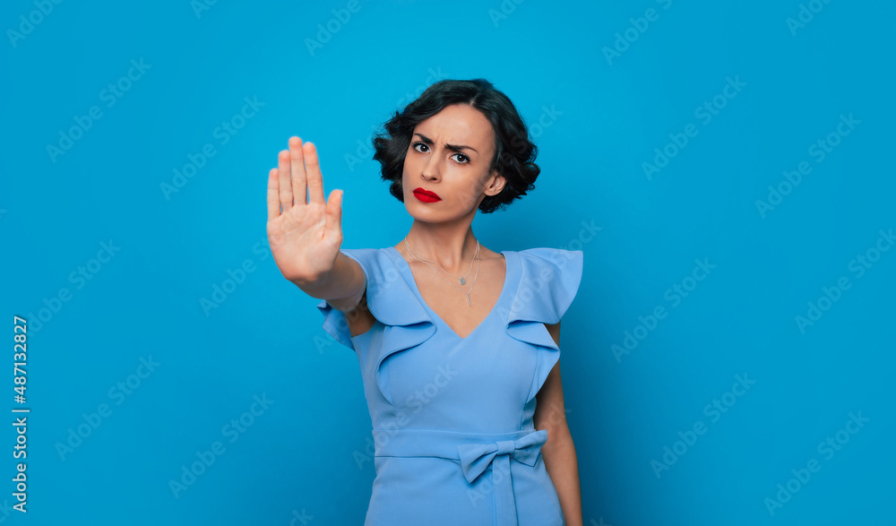 Women's rights. Feminism. Equality of gender. Serious strong conceptual woman feminist shows stop gesture on camera. International womens day Women's rights. Feminism. Equality of gender. Serious strong conceptual woman feminist shows stop gesture on camera. International womens day