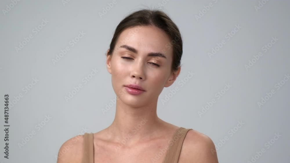 Beautiful young asian woman with perfect skin. Portrait on the shoulders. Spa, health and skin care. Advertising of cosmetics. Gray background. Beautiful young asian woman with perfect skin. Portrait on the shoulders. Spa, health and skin care. Advertising of cosmetics. Gray background.
