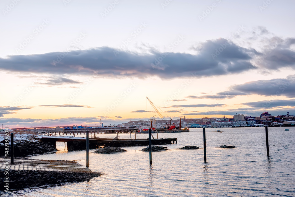 An old ruined pier in the bay and a view of the evening city. Portland. USA. Maine.
