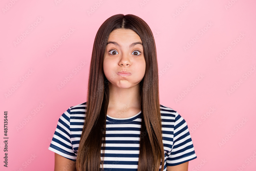 Photo of fooling funky girl dressed striped clothes big eyes bloated cheeks isolated pink color background Photo of fooling funky girl dressed striped clothes big eyes bloated cheeks isolated pink color background
