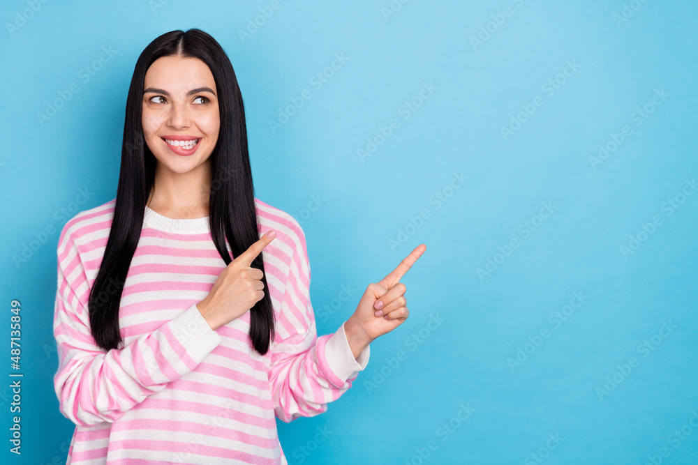 Photo of young cheerful lady curious look indicate fingers empty space ads promo select follow isolated over blue color background Photo of young cheerful lady curious look indicate fingers empty space ads promo select follow isolated over blue color background