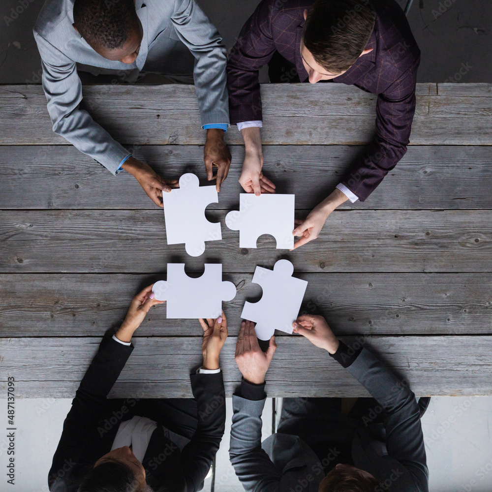 Business people assembling jigsaw puzzle Stock Photo | Adobe Stock