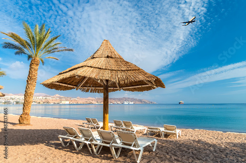Morning on central beach of the Red Sea in Eilat - famous tourist resort and recreational city in Israel