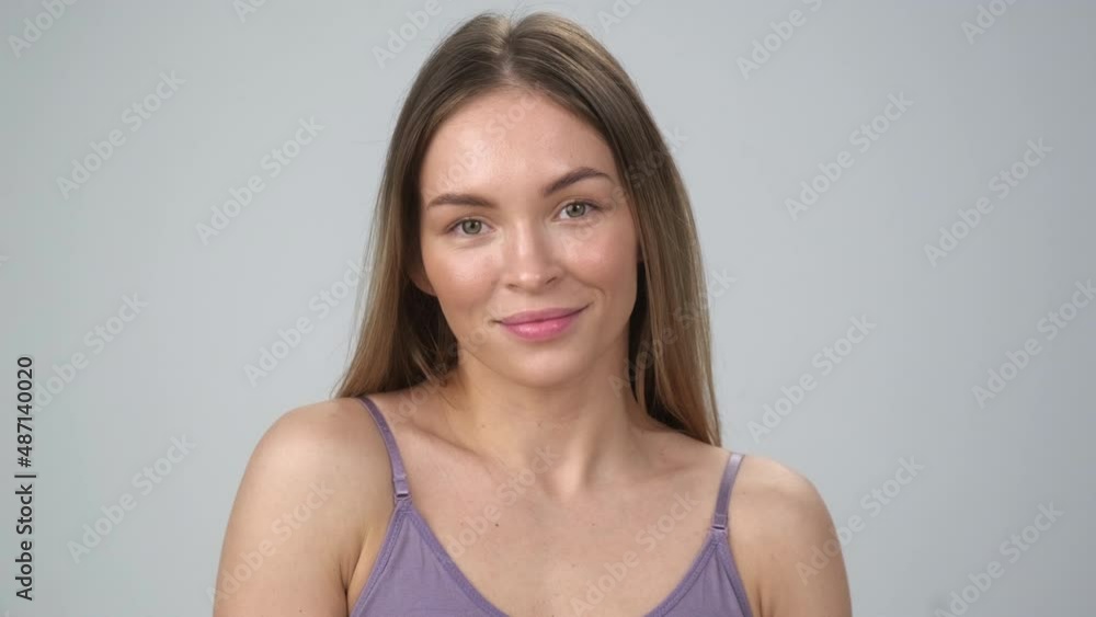 Beautiful young woman with perfect skin. Portrait on the shoulders. Spa, health and skin care. Advertising of cosmetics. Gray background. Beautiful young woman with perfect skin. Portrait on the shoulders. Spa, health and skin care. Advertising of cosmetics. Gray background.