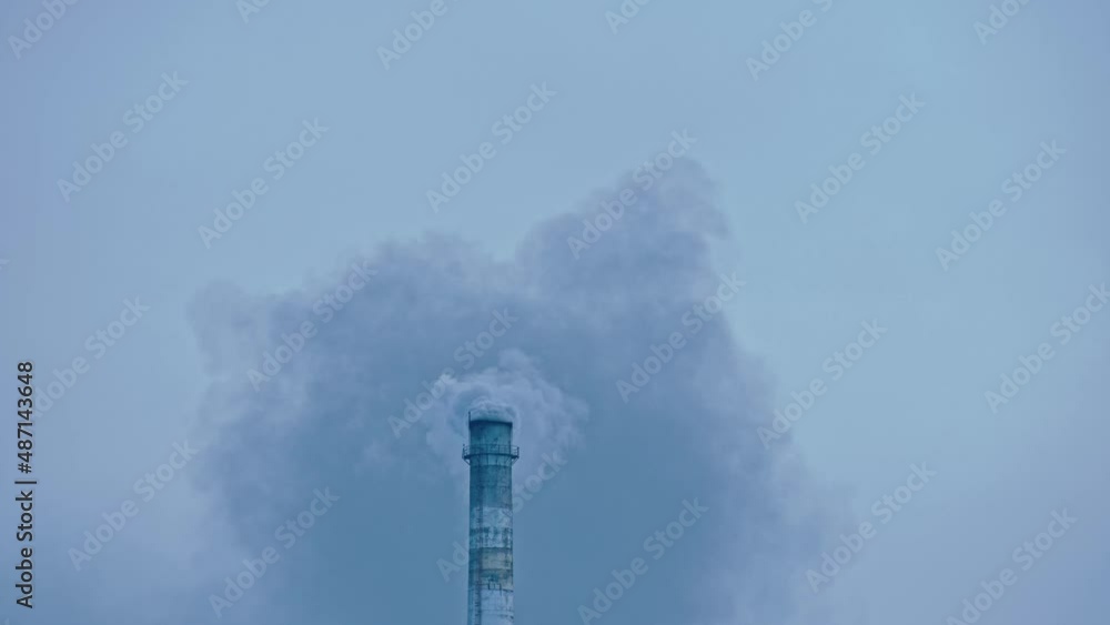This smoke coming from the chimney in a factory. Harmful emissions into the atmosphere, from the pipe. Serious damage the environment. Plant stack Coaling station. Close up shot. Dark sad view. This smoke coming from the chimney in a factory. Harmful emissions into the atmosphere, from the pipe. Serious damage the environment. Plant stack Coaling station. Close up shot. Dark sad view.