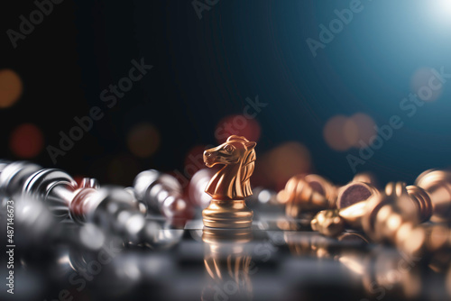 Chess (knight wins the game) on black background. Success, business strategy, victory, win, winner, tactics, defeat, beat, knock or checkmate concept. photo