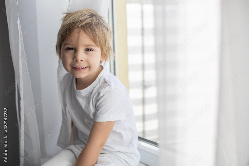 Cute happy toddler boy, child in white cloths, smiling at camera Cute happy toddler boy, child in white cloths, smiling at camera