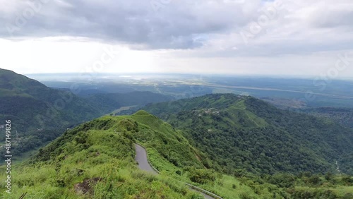 mountain curvy tarmac road with dramatic sky at morning photo