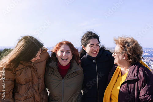 Group of women of different ages laughing in each other's arms. Woman concept. Feminism concept.