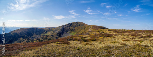 Beautiful landscape with a mountain plateau, the covering of which is a mountain, upper tundra and blue sky.