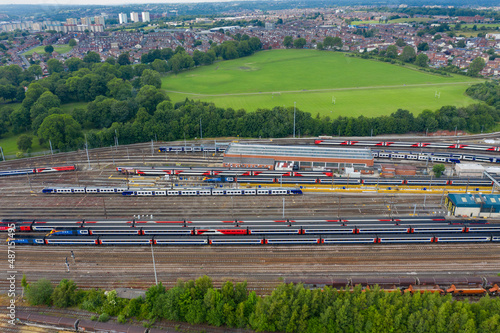 Obraz na płótnie Aerial Photo of a train station works depot with lots of trains in the tracks located in the village of Halton Moor in Leeds, West Yorkshire in the UK on a bright sunny summers day. w salonie