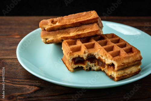 Viennese waffles on dark wooden background.