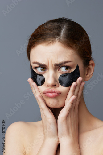 beautiful woman with patches on the face clean skin health rejuvenation isolated background