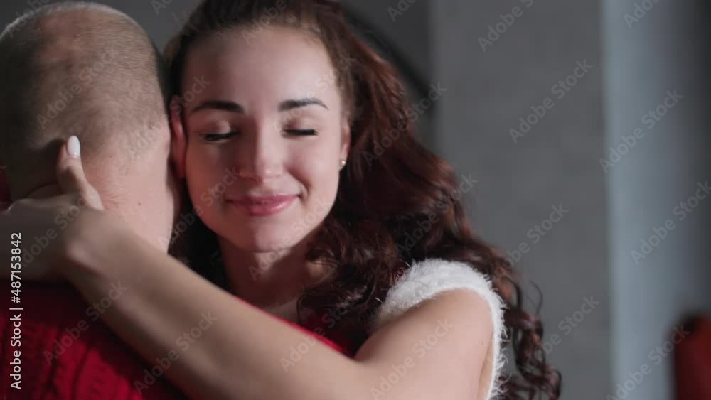 family relationships, a cute woman with a loving man hugging during a romantic evening at home, close-up family relationships, a cute woman with a loving man hugging during a romantic evening at home, close-up