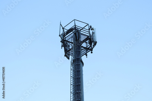Telecommunication tower of 4G and 5G cellular. Macro Base Station. 5G radio network telecommunication equipment with radio modules and smart antennas mounted on a metal. Blue sky in the background.