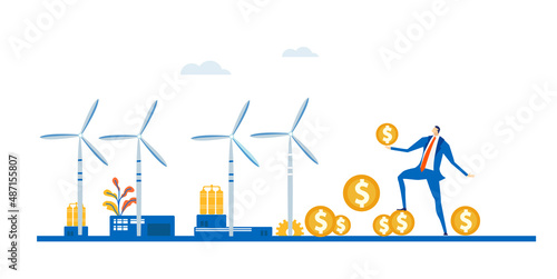 Businessman with coins stands next to wind power turbines