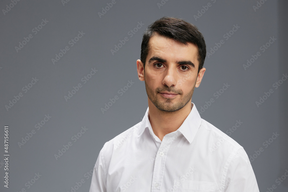 manager in a white shirt a pensive look Gray background manager in a white shirt a pensive look Gray background