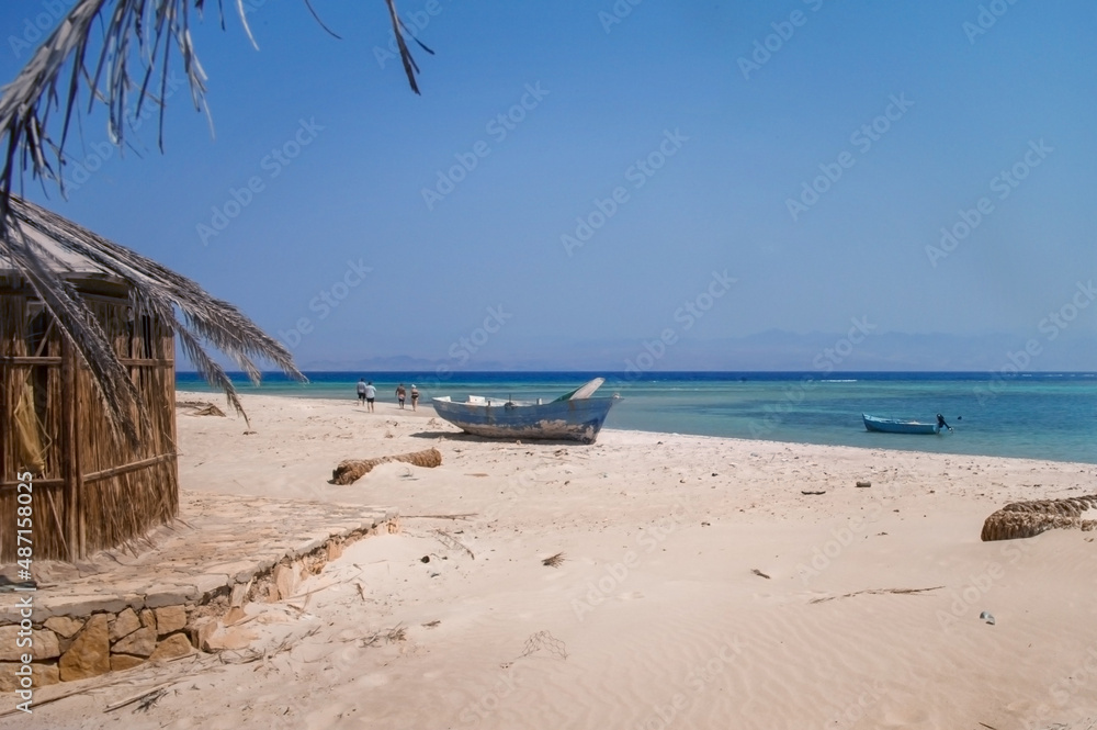 old wooden fishing boats resting on the beach of the bay blue lagoon in egypt