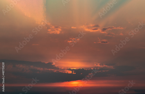 Beautiful orange sunset sky above clouds with dramatic light, Beautiful blazing sunset landscape, Copy space, No focus, specifically. © num