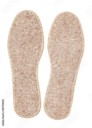 Felt insoles isolated on white background. Two warm insoles for shoes
