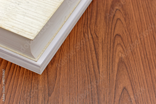 Books and sheets on wooden desk.