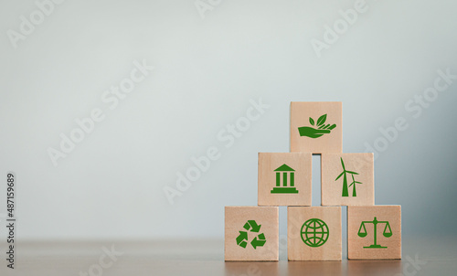 ESG Concepts on Environment, Society and Governance Revolving Sustainable Organization Development Wooden block with environmental ESG icon on gray background. copy space photo