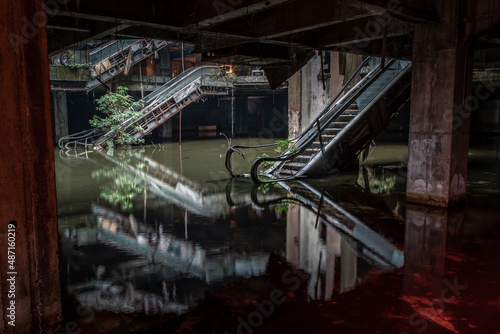 Bangkok, Thailand - 07 Feb 2022 : Damaged escalators and waterlogged in abandoned shopping mall building. Structural and ruins was left to deteriorate over time, New World Mall, Selective focus.