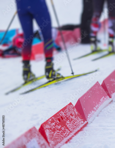 Alpine skiing race slalom competition, athletes ready to start ski competitions on a piste slope, nordic ski skier on the track in winter, giant slalom, winter sport and acitivities concept photo