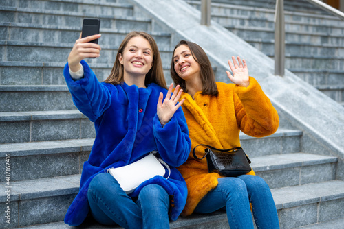 two generation z girls taking selfie  friends making video call outdoor  generation z concept