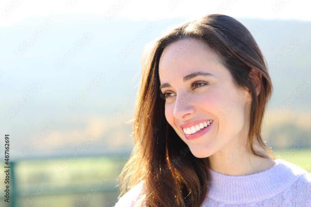 Portrait of a woman with perfect smile looking at side Portrait of a woman with perfect smile looking at side