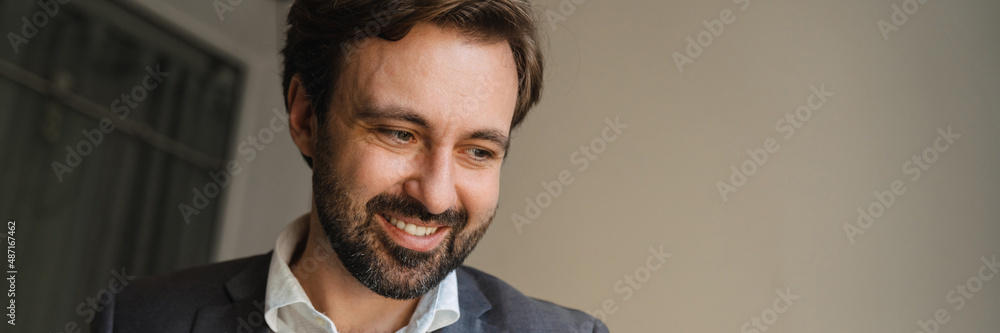 Fototapeta premium Smiling mid aged businessman looking at laptop