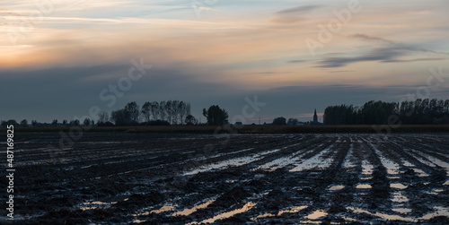 View over cultivated land at the Belgian countryside during sunset around Blankenberge photo