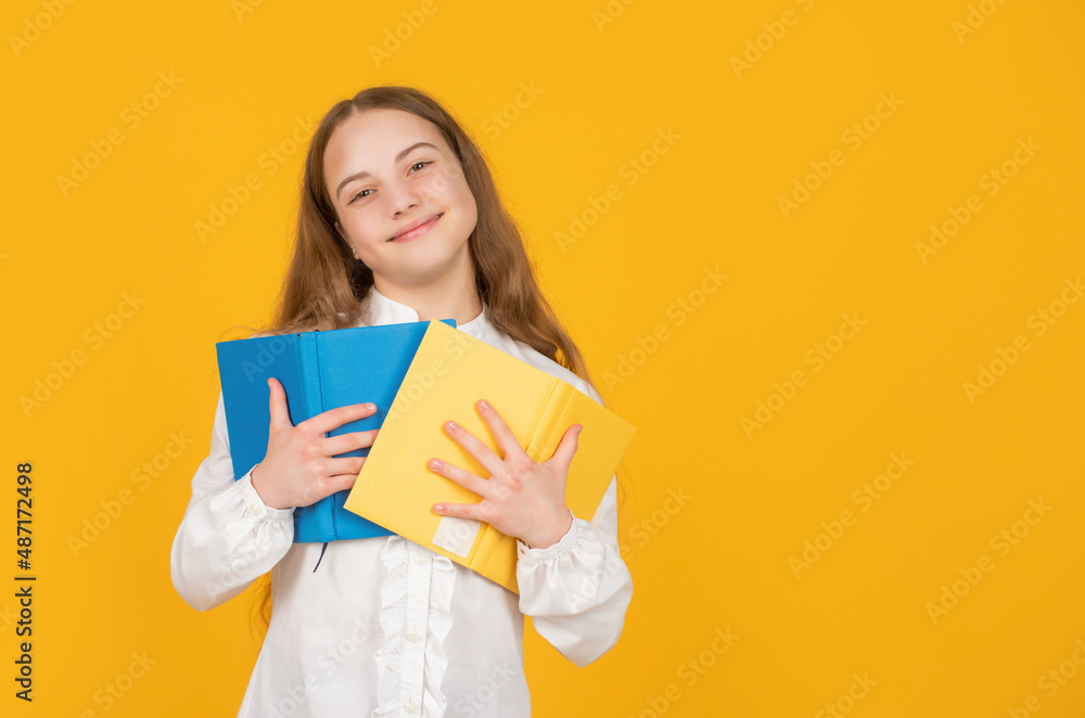 cheerful child hold school book on yellow background with copy space, education cheerful child hold school book on yellow background with copy space, education