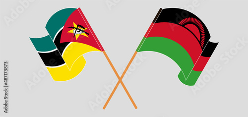 Crossed and waving flags of Mozambique and Malawi