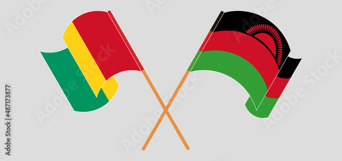 Crossed and waving flags of Guinea and Malawi