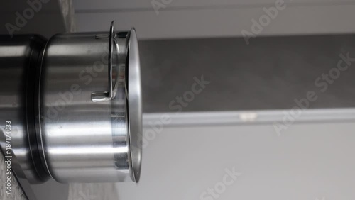 Steam rises from a stainless steel saucepan. Vertical video