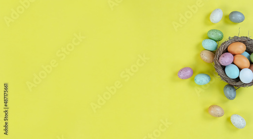 Right border of nest and eggs on a bright yellow background for a happy Easter holiday season