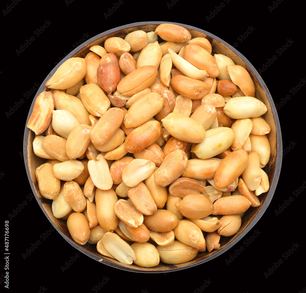 Processed peanuts isolated in wood bowl on black background Processed peanuts isolated in wood bowl on black background